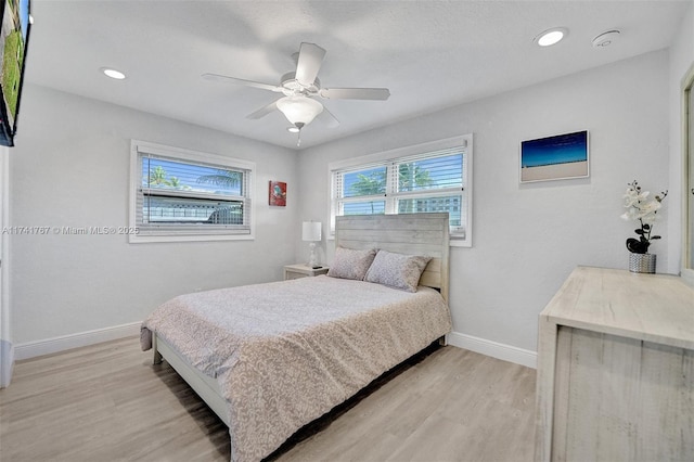 bedroom with ceiling fan and light hardwood / wood-style floors