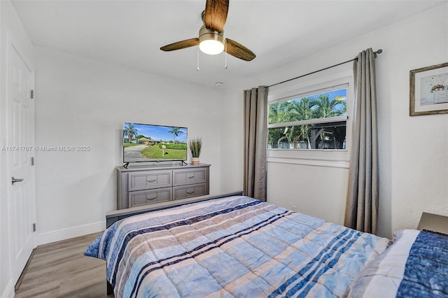 bedroom with ceiling fan and light wood-type flooring