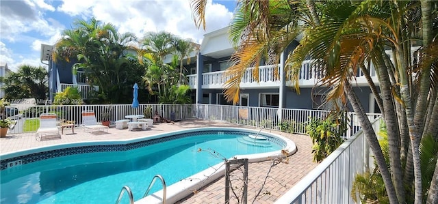 view of swimming pool featuring a patio area