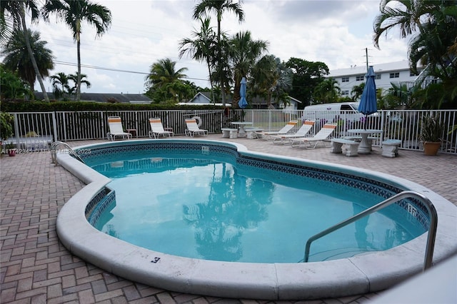 view of swimming pool with a patio