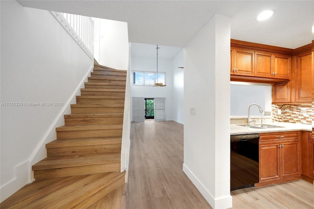 stairway with sink and hardwood / wood-style floors