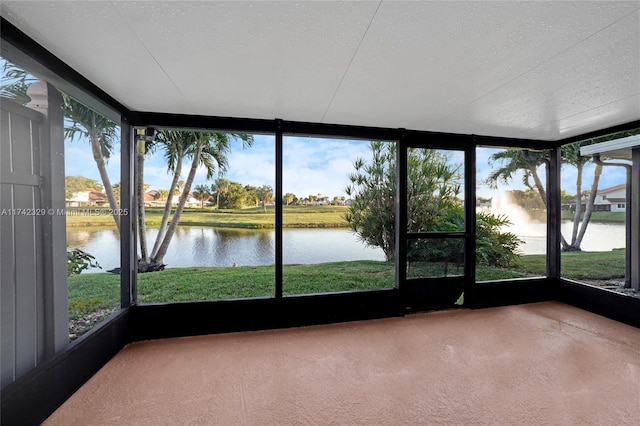 unfurnished sunroom featuring a water view