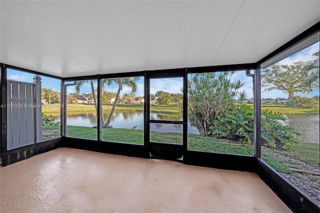 unfurnished sunroom with a water view