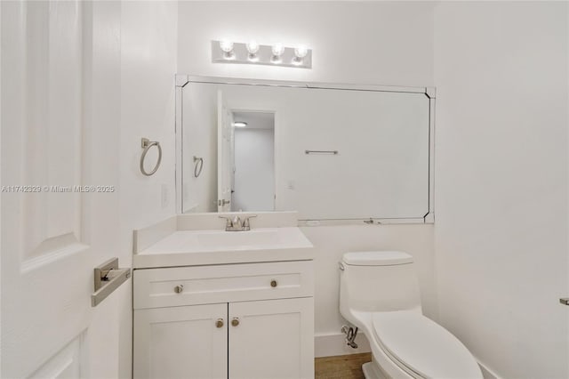 bathroom featuring vanity and toilet