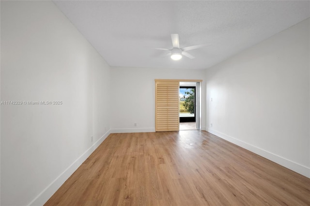 empty room with light hardwood / wood-style flooring and ceiling fan