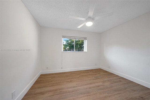 unfurnished room with hardwood / wood-style floors, a textured ceiling, and ceiling fan