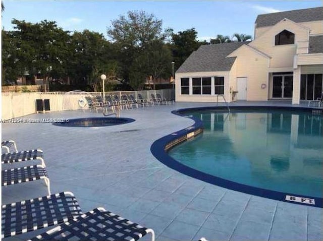 view of swimming pool with a patio area