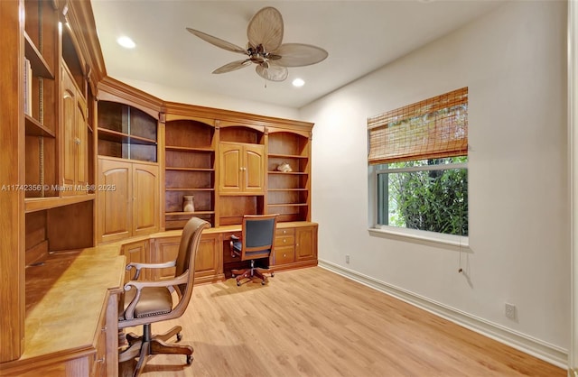 office space featuring recessed lighting, a ceiling fan, baseboards, built in study area, and light wood finished floors