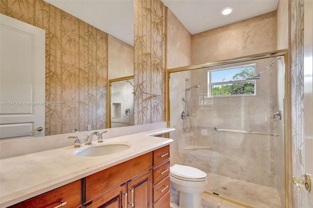 full bathroom with toilet, wallpapered walls, a shower stall, and vanity