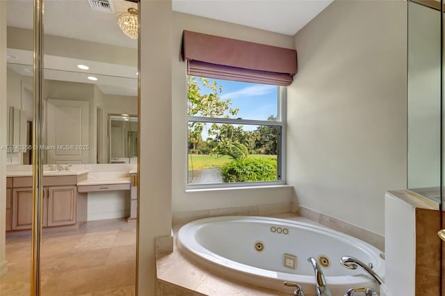 full bathroom with a whirlpool tub, vanity, visible vents, and tile patterned floors