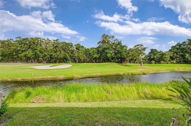 surrounding community featuring a water view and a yard