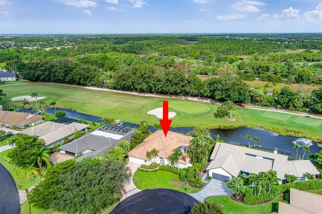 bird's eye view with view of golf course, a water view, and a wooded view