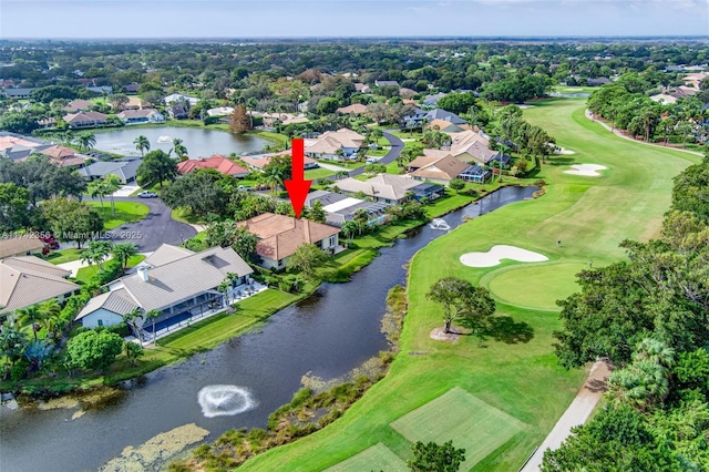 aerial view with view of golf course, a water view, and a residential view