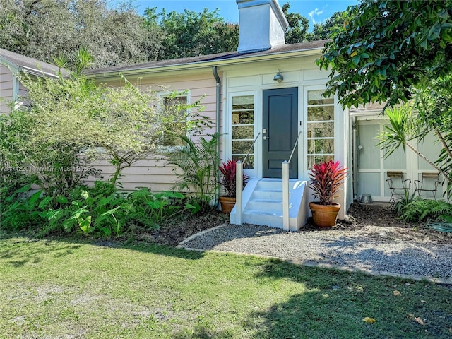 property entrance with a yard