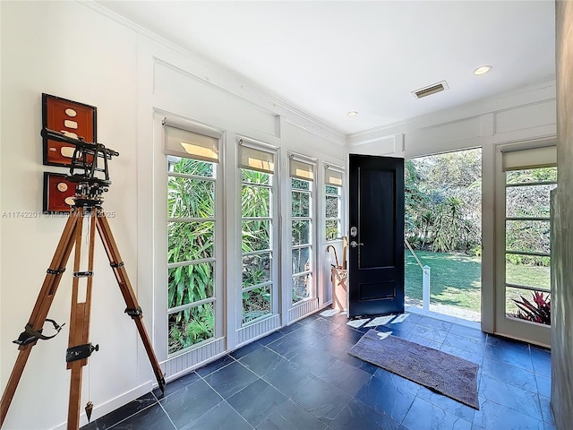 doorway featuring a wealth of natural light, recessed lighting, visible vents, and ornamental molding