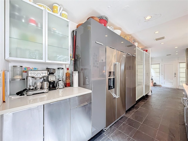 kitchen featuring visible vents, modern cabinets, light countertops, recessed lighting, and gray cabinetry