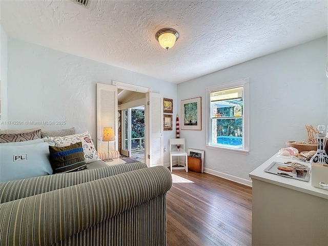 bedroom featuring dark hardwood / wood-style floors and a textured ceiling