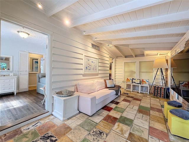 living room featuring wood ceiling, wooden walls, and beam ceiling