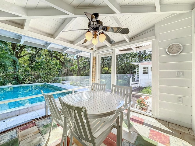 sunroom featuring a fenced in pool, a patio, and ceiling fan