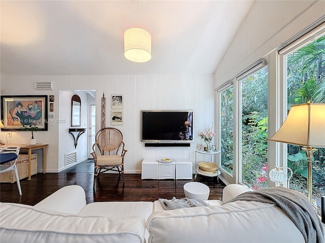 living room with dark wood-type flooring and vaulted ceiling