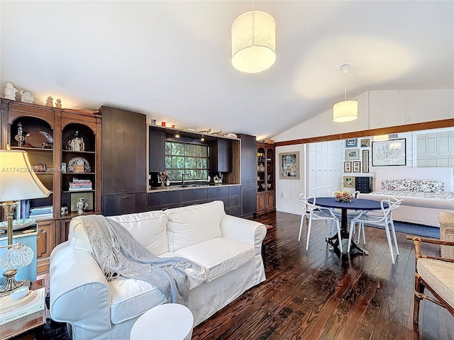 living room featuring vaulted ceiling and dark wood finished floors