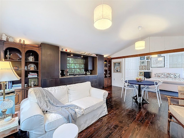 living room featuring lofted ceiling, sink, and dark wood-type flooring