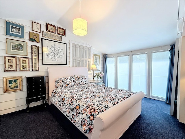 carpeted bedroom featuring vaulted ceiling and access to outside