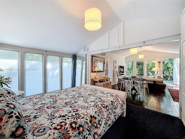 bedroom with lofted ceiling, access to exterior, and wood-type flooring