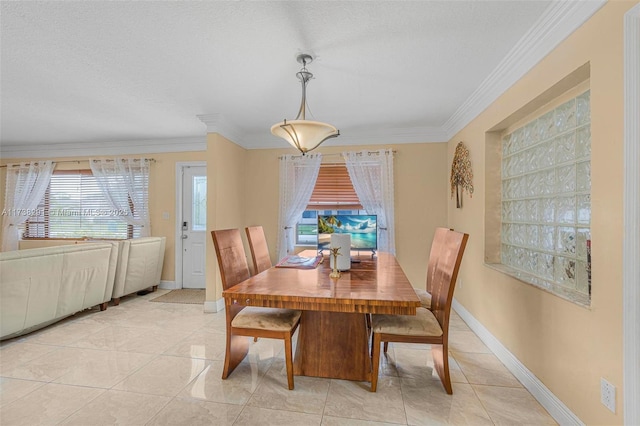 tiled dining room with ornamental molding and a textured ceiling