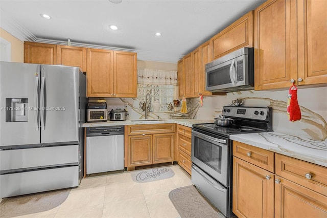 kitchen with light stone counters, stainless steel appliances, sink, and light tile patterned floors