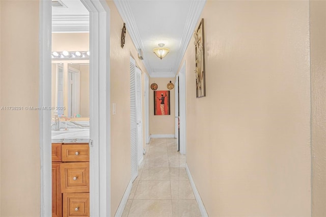 hall with crown molding and light tile patterned floors