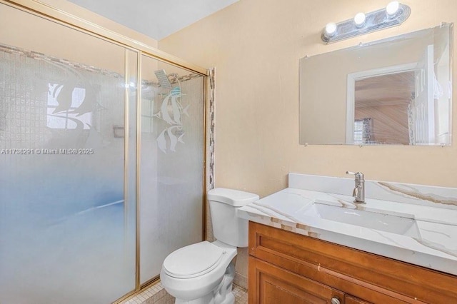 bathroom featuring tile patterned flooring, vanity, toilet, and walk in shower