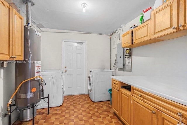 clothes washing area featuring cabinets, electric panel, and washer and clothes dryer