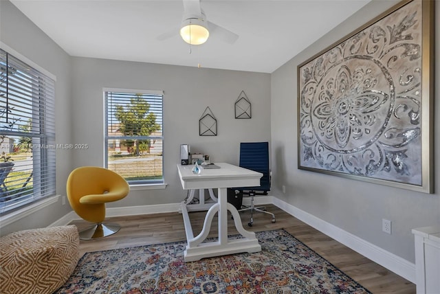 office space with dark wood-type flooring and ceiling fan