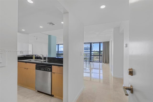 kitchen featuring sink, expansive windows, and dishwasher