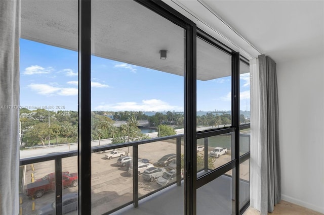 doorway to outside with a water view