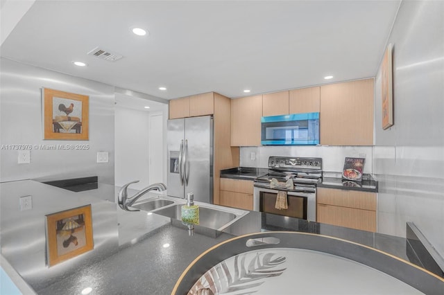 kitchen with stainless steel appliances, sink, and light brown cabinets