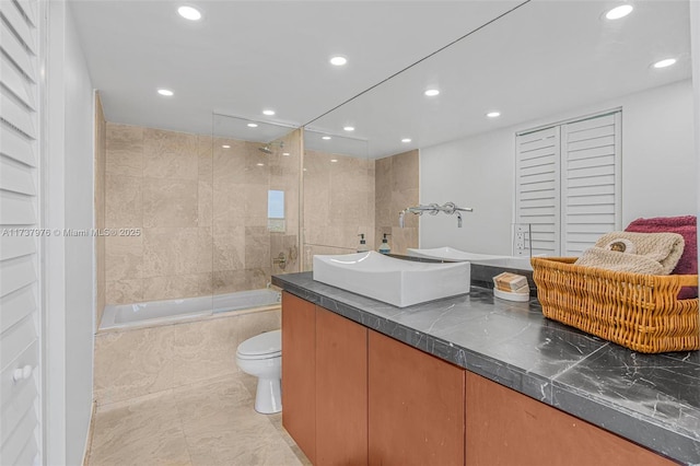 full bathroom with vanity, toilet, and tiled shower / bath combo