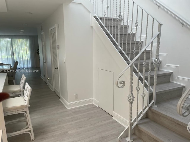 stairway featuring hardwood / wood-style flooring