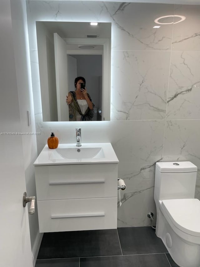 bathroom featuring vanity, toilet, and tile patterned flooring