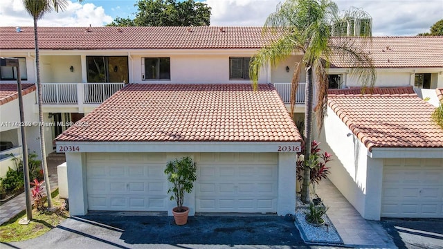 view of front of house featuring a balcony and a garage