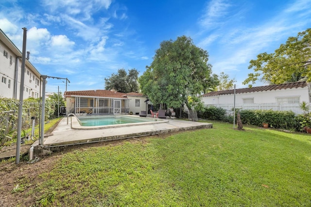 view of yard with a fenced in pool and a patio