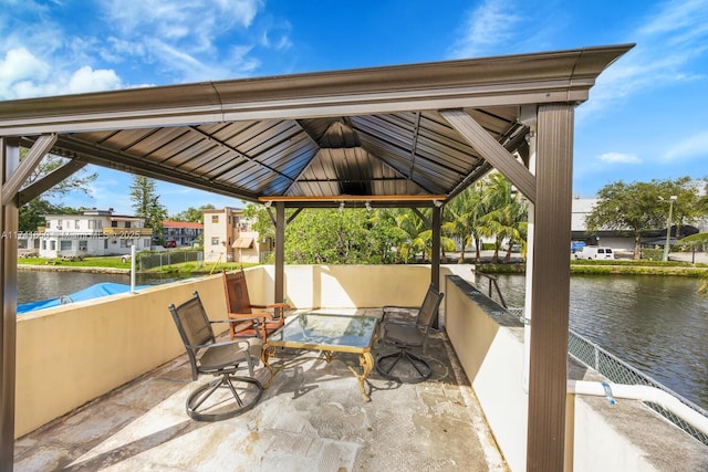 view of patio with a gazebo and a water view