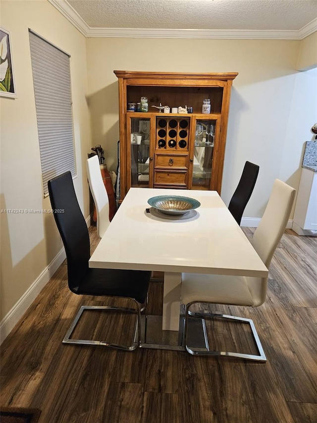 dining space with ornamental molding, dark hardwood / wood-style flooring, and a textured ceiling