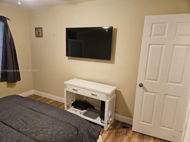 bedroom with hardwood / wood-style floors