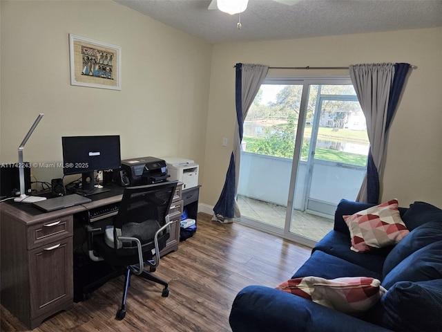 office with ceiling fan, light hardwood / wood-style flooring, and a textured ceiling