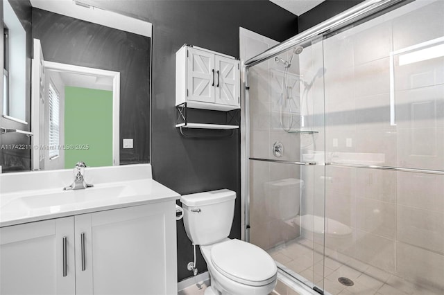 bathroom with vanity, a shower with shower door, and toilet