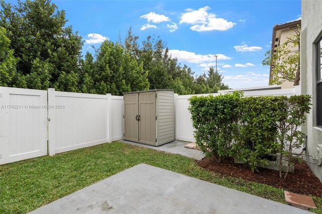 view of yard featuring a shed and a patio