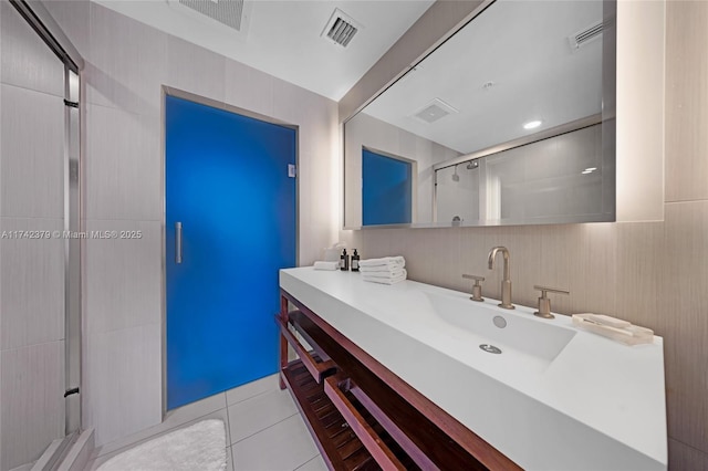 bathroom featuring an enclosed shower, vanity, and tile patterned floors