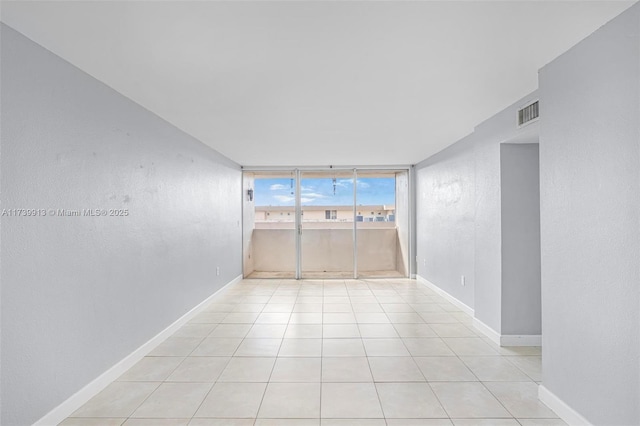 unfurnished room with light tile patterned floors